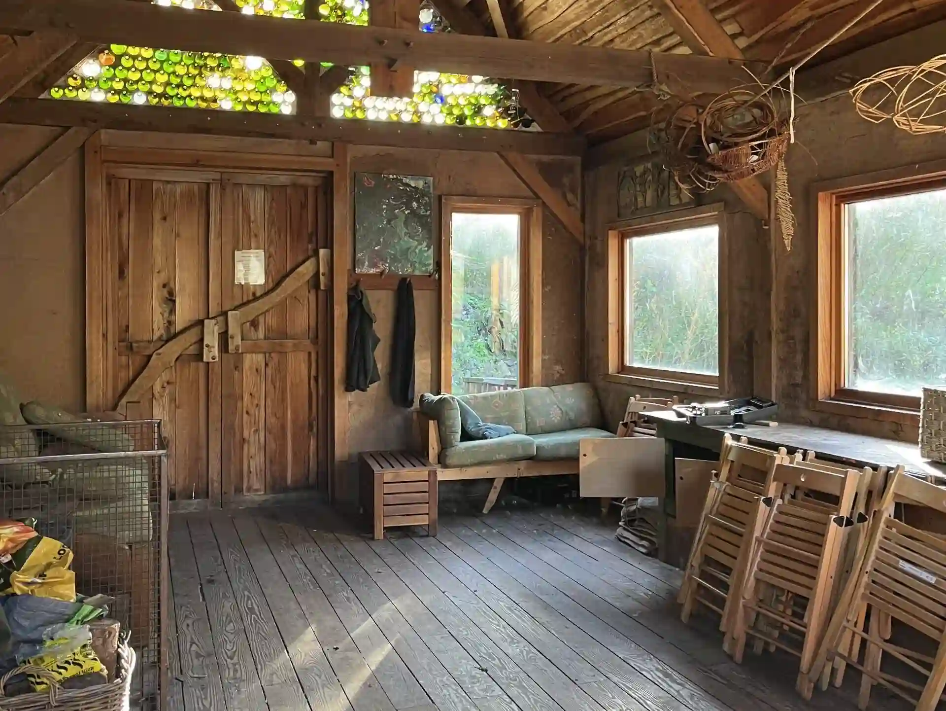 Inside The Larch Barn, a rustic timber barn with bottle-glass skylights and woodland views